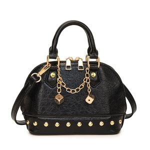 Elegant black shell handbag with gold chain charms and rivet detailing on a white background
