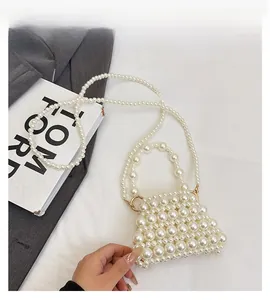 Detailed view of handmade beaded pearl handbag with cream luster and trapezoidal shape
