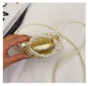 Close-up of handmade pearl woven mini bag showing interior space for small cosmetics