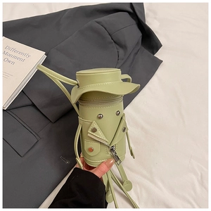 Detail of light green cartoon crossbody bag with mini jacket style and metal zipper