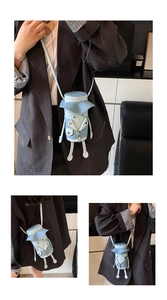 Detail of a light blue cartoon-styled crossbody bag with soft doll-like limbs and shoulder strap