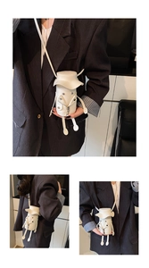 Close-up of a white novelty humanoid crossbody bag featuring motorcycle jacket details