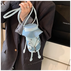Detail of creative blue denim cartoon jacket shaped crossbody bag held by a model