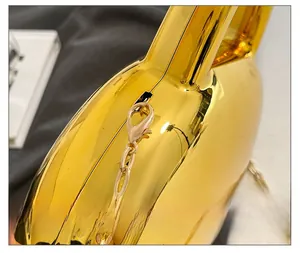 Detail of high-quality gold metal chain and lobster clasp on mirror heart bag