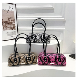 Three boston handbags with faux snakeskin patterns in black-white, tan and bright pink