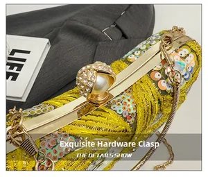 Detail of glitter evening bag featuring a pearl rhinestone clasp and gold metal frame
