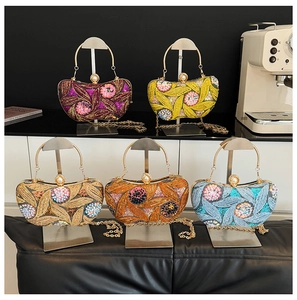 Detail view of colorful sequin evening bags with pearl clasps and metal chain straps