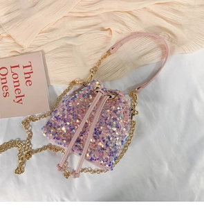Detail of pink sequin bucket bag featuring drawstring closure and gold chain strap