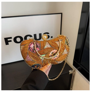 Detail of floral gold embroidery and multicolored sequins on a luxury evening clutch