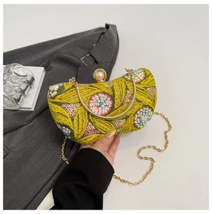 Detail of yellow sequin evening bag with leaf embroidery and large pearl clasp