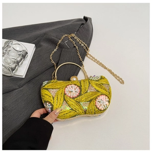 Detailed embroidery and sequins on vintage green evening bag with gold ring handle