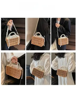 Detail view of woven basket bag with pearl top handle and shoulder strap on model