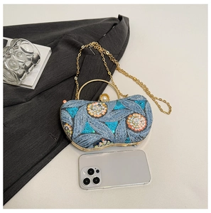 Detail of sequin floral embroidery and large pearl clasp on the vintage evening bag