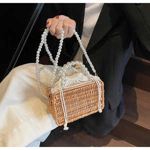 Detailed macro view of retro woven rattan bag with elegant pearl handles and cotton lining