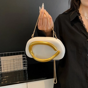 Minimalist white shell bag with large gold metal hardware and elegant chain strap