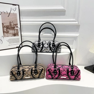 Three stylish snakeskin hobo bags in black, brown, and pink on minimalist white stairs
