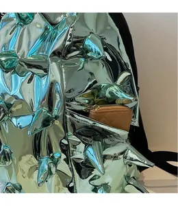 Detail view of the side pocket on the green metallic spike backpack holding a wallet