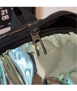 Macro shot of futuristic laser mirror fabric and black metal zipper pull on a handbag