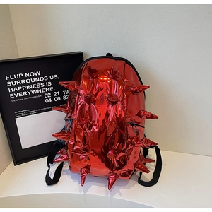 Detail shot of a creative red 3D hedgehog backpack with glossy metallic spikes