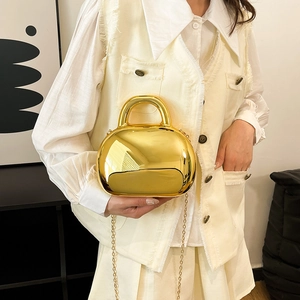 Glossy gold shell handbag with metallic mirror finish and elegant metal chain strap