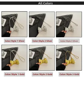 Detail of metallic bow-shaped mini bag with pearl and metal chain options