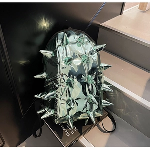 Detail of metallic green punk backpack featuring 3D spikes and high-gloss reflective finish