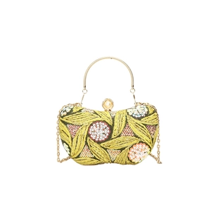 Chinese style evening bag with heavy embroidery, sequins, and golden ring handle