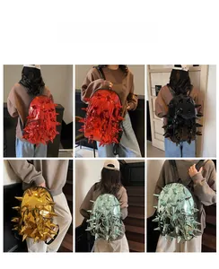 Detailed views of spiked backpack in metallic red, gold, and black finishes on a model
