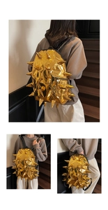 Detail of creative gold spike backpack featuring 3D metallic punk studs and zipper pockets