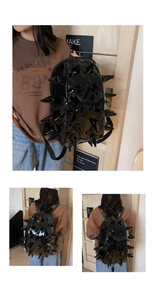Detail of glossy black hedgehog backpack with punk spikes and 3D textured surface