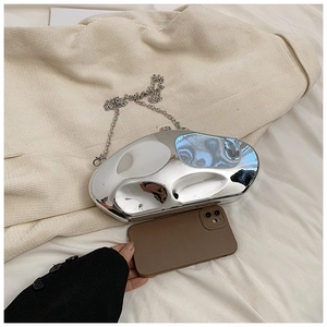 Detail of silver mirror acrylic evening bag with metallic chain and teardrop shape