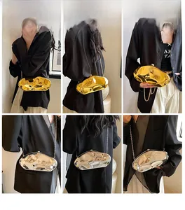 Detailed view of fluid metallic crossbody bags in gold and silver mirror finishes