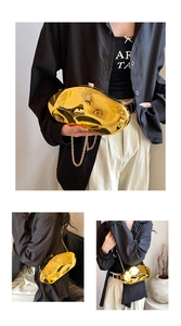 Detail of liquid metal gold acrylic clutch with irregular fluid shape and chain strap