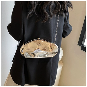 Detail of silver liquid metal acrylic clutch bag with mirror finish and chain strap