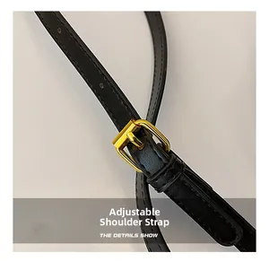 Detail of adjustable black leather strap with premium gold metal buckle and stitching