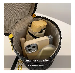 Internal capacity of rhinestone cylinder bag showing space for phone and umbrella