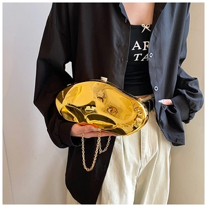 Close-up of a glossy mirror gold irregular acrylic clutch bag with thin gold chain strap