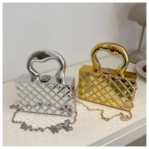 Detail view of gold and silver metallic box bags with quilted texture and chain strap