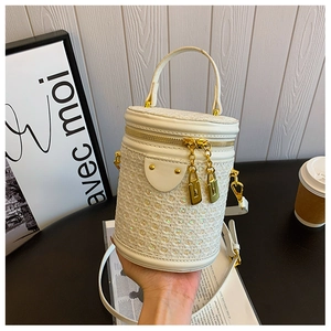 Macro shot of white cylindrical bag with iridescent sequins and gold zippers