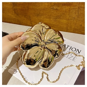 Detailed view of a gold flower-shaped chain bag with mirror-finish metallic texture