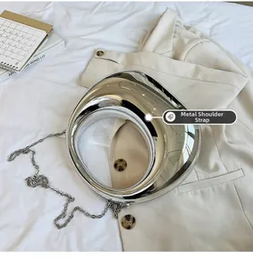 Vue détaillée du sac argenté à effet miroir avec bandoulière chaîne et anse creuse
