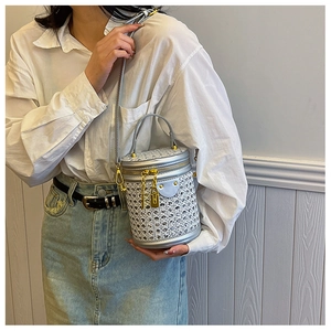 Detail of silver rhinestone cylinder bag with gold padlock hardware and chain strap
