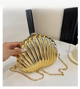 Macro shot of gold shell evening bag featuring radial ribbed texture and spherical clasp