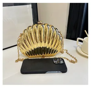 Interior view showing shiny gold shell clutch capacity with a smartphone