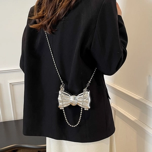 Chic silver bow-shaped metallic mini bag with a fine pearl chain strap for women