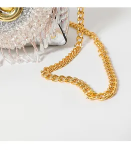 Close-up of luxury gold chain strap and sparkling silver rhinestone fringe on evening bag