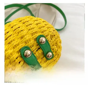 Detail of the pineapple woven bag showing golden metal base studs and craftsmanship