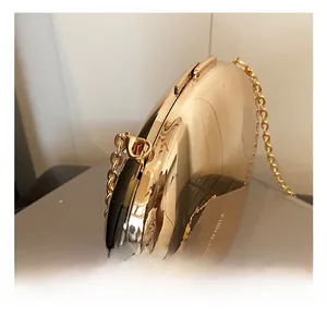 Close-up of premium gold metal hooks and chain links on acrylic clutch bag