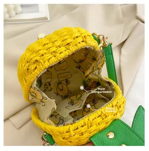 Detail view of woven pineapple bag interior with main pocket and phone compartment