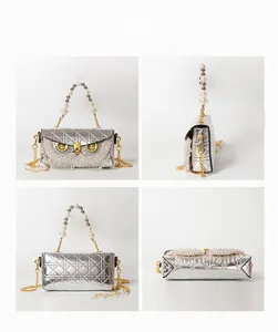 Detailed angle display of silver owl-shaped shoulder bag with beaded tassels and pearls